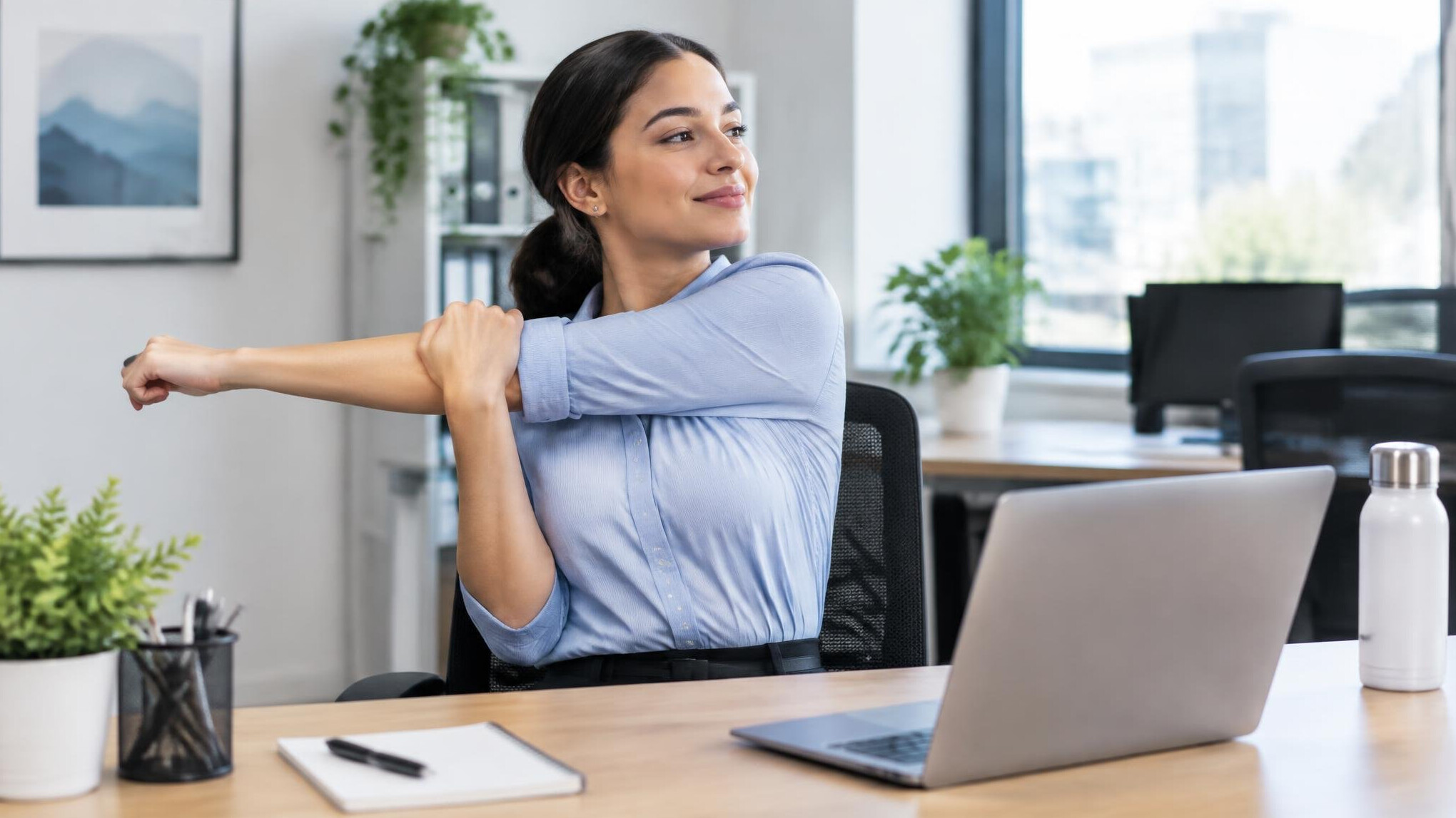 office worker stretching at desk